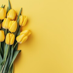 A bouquet of vibrant yellow tulips arranged on a bright yellow background. The flowers have green leaves and are fresh and lively.