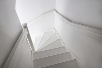 White painted wooden stairs with a corner. Scandinavian home decor concept.