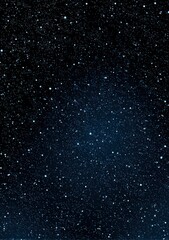 Fototapeta premium The night sky is filled with numerous stars and wispy clouds overhead