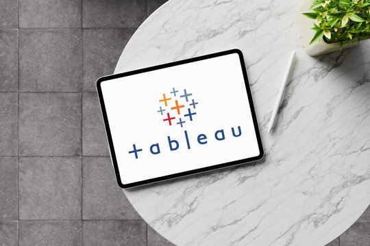 Tableau software logo displayed on tablet screen on marble table