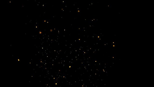Floating golden dust particles in dark background