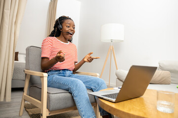 Young woman having a video call and looking excited