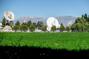 Panoramic view of large satellite dishes at the Fucino Space Centre, set against a backdrop of...