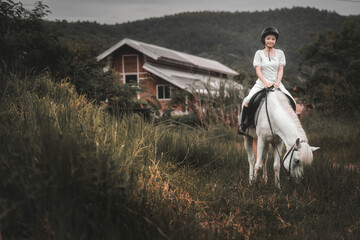 Young Woman Riding White Horse Near Rustic House in Nature
