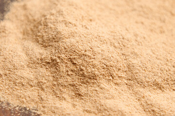 Ground Ashwagandha root powder. Dried Ayurvedic anti-stress supplement. Macro shot. 