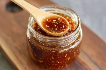 Delicious Sweet and Spicy Chili Sauce in Glass Jar with Spoon