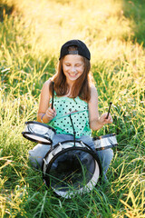 Happy caucasian kid girl drummer. Girl playing on drum kit. Emotional portrait. Portrait of smiling beautiful drummer girl crossed arms smiling at camera posing. Cheerful little girl playing drum