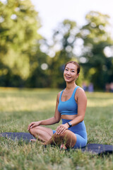 Woman Practicing Yoga Outdoors in a Park on a Sunny Day