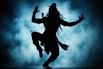 Isolated silhouette illustration of Shiva Nataraja, the cosmic dancer, against a vibrant smoky blue background, embodying divine energy and transformation.