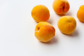 Fresh ripe apricots on a white background.