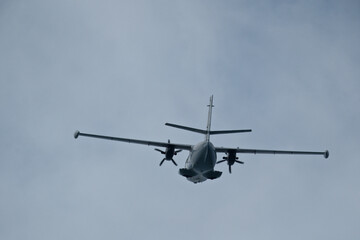 The plane moving away after takeoff. Airplane flying in the blue sky. 