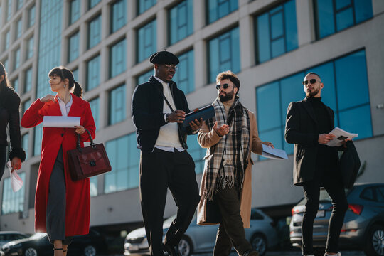 Group of individuals demonstrating a professional team dynamic as they walk and communicate. Collaborative office attire highlights teamwork and business-oriented discussion outdoors near a corporate - Powered by Adobe