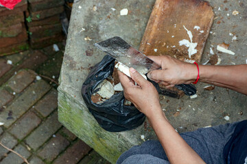 Peeling Cassava Root with Cleaver