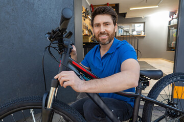 Mechanic fine-tunes handlebars of black mountain bike in indoor setting with in modern workshop...