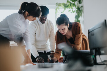 Three professionals work together on a project, collaborating and brainstorming ideas in a modern...