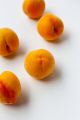 Fresh ripe apricots on a white background.