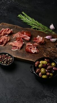 Gourmet charcuterie board with prosciutto and olives: culinary art display in sequence