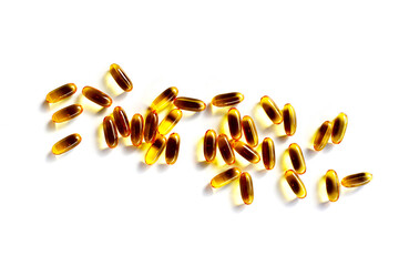 Golden fish oil capsules on white background.