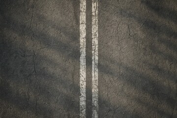 Weathered asphalt road surface with worn white double lines, creating a textured background from an overhead perspective, ideal for concepts of direction, journey, or urban decay.