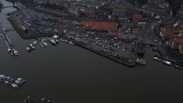 Aerial video filmed with DJI Mini 3 Pro flying from Whitby Abbey towards the River Esk, descending over the historic town and harbour with sweeping coastal views.