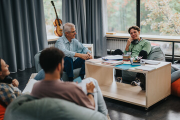 A professor interacts with students in a relaxed setting, fostering discussion and learning. The...