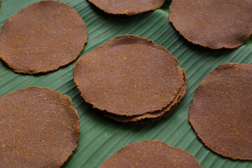 Fermented soybean discs, known as “Thua Nao,” a traditional Thai seasoning used to enhance flavor in Northern cuisine.