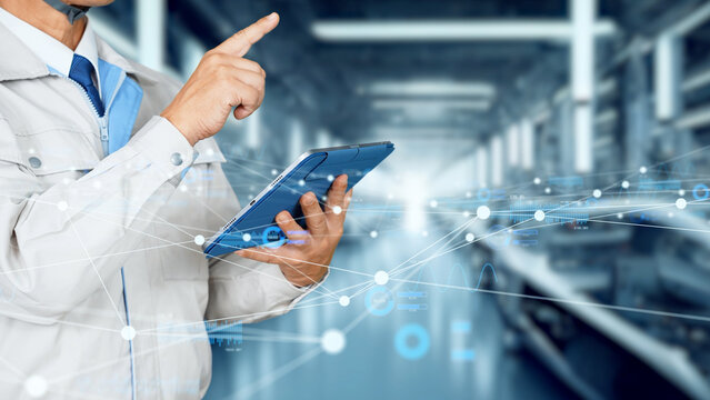 Digital network with engineers using tablets in factory