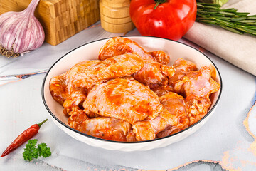 Raw marinated uncooked chicken wings