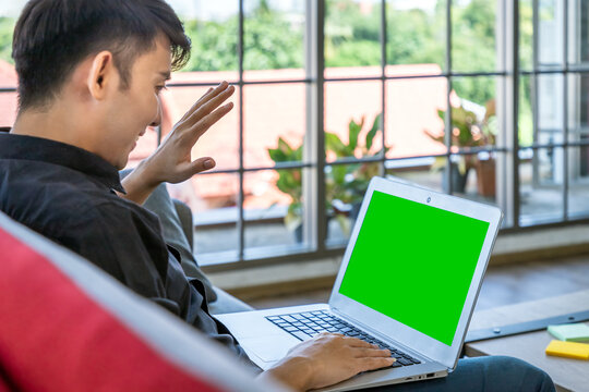 Young Asian man video call communication laptop green screen home office living room