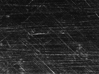 Textured black surface with scratches and marks showing signs of wear and use over time