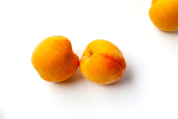Fresh ripe apricots on a white background.