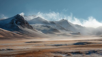 Majestic snow dusted mountains under a vast sky with wispy clouds