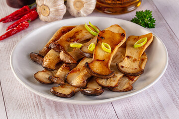 Roasted eringi mushrooms in the plate