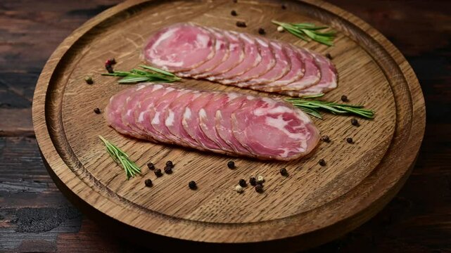 Gourmet italian coppa capocollo presentation with rustic wooden platter and fresh herbs