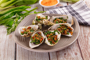 Gournet grilled oysters with onion and peanut