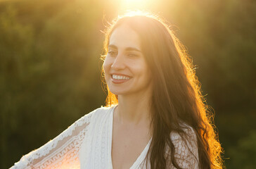 Portrait of a beautiful laughing woman at sunset