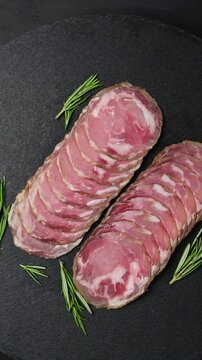 Artisan coppa capocollo: traditional italian charcuterie presentation with fresh herbs