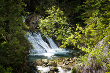 Obraz premium Mountain waterfall, falling water with a roar, mountain landscape. 