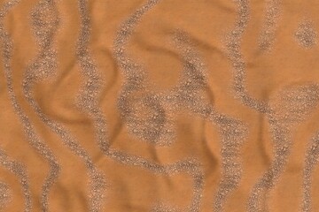 A close-up shot reveals a textured, rust-orange fabric with subtle, darker speckles throughout. The material is softly draped, creating gentle folds and wrinkles across the surface.  