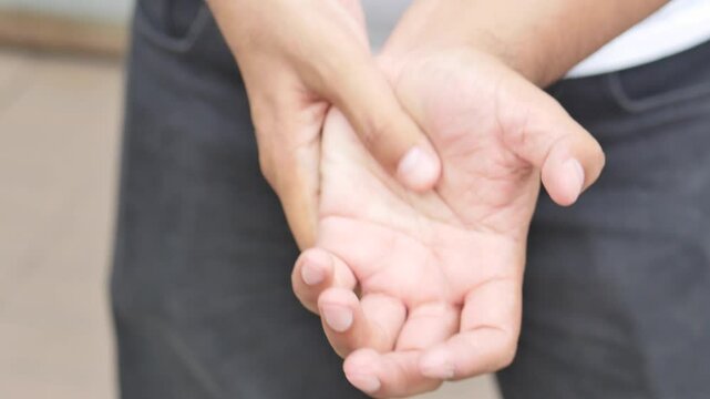 Middle aged old asian man suffering from trigger finger, CTS or carpal tunnel syndrome, gout disease, arthritis inflammation, hand pain, health care or body care concept image