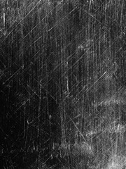Surface texture with scratches and marks created over time on a dark background in an indoor setting