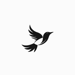 Obraz premium Elegant Black and White Bird Silhouette in Flight, Minimalist Design