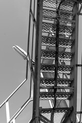 Sturdy metal ladder leads to heights against a clear sky, revealing a glimpse of adventure and...