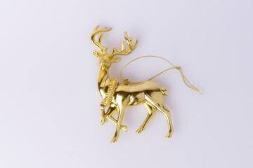 Elegant golden reindeer statuette isolated on white background. Perfect for Christmas, New Year, festive decorations, and winter holiday themes.