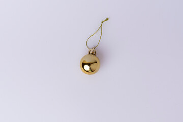 Golden Christmas ball ornament isolated on white background. Festive holiday decoration perfect for seasonal designs, greeting cards, and Christmas-themed projects.