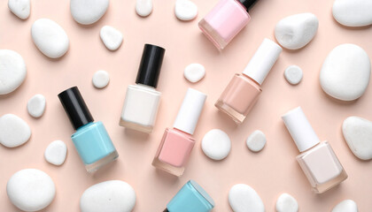 Obraz premium Cosmetic Serenity: An overhead shot showcases a collection of nail polish bottles in an array of soft, pastel hues, delicately arranged amongst smooth, white stones, evoking a sense of calm beauty.