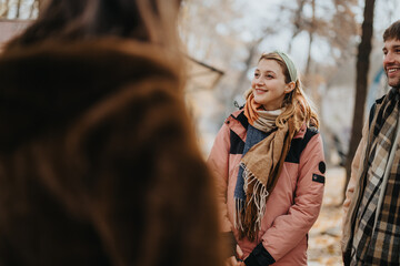 Friends enjoying an outdoor meet up among autumn scenery, fostering warmth and camaraderie outdoors.