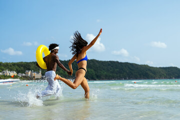 Pure happiness. A young diverse, multiethnic couple enjoys every moment of their tropical getaway