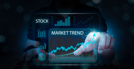 Investors trade on a virtual screen, with financial stock market statistics graphs on the screen, stock prices, and online trading data in the foreground. Growth graph, invest concept.