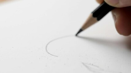 A hand drawing a circle on white paper with a black pencil - Powered by Adobe